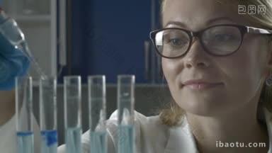 戴<strong>防</strong>护<strong>眼镜</strong>和手套的年轻女科学家在科学化学实验室用移液管将液体物质滴入试管