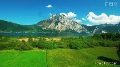 空中全景的山旁边的湖与游艇空中全景的云和蓝色的天空在奥地利
