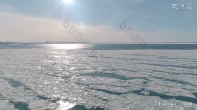 俯瞰城市和阳光的冰冷海面上的冰的鸟瞰图