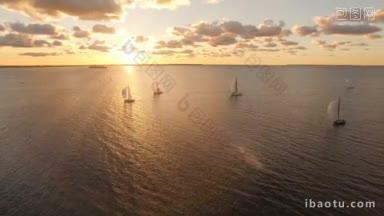 航拍的游艇与帆在海上与美丽的日落景观游艇在开阔的海上