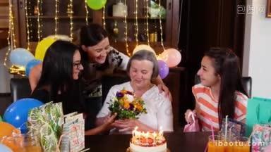 在生日聚会上，年长的母亲带着女儿和孙女，拿着鲜花和礼物，庆祝两代人之间的生活和爱的概念
