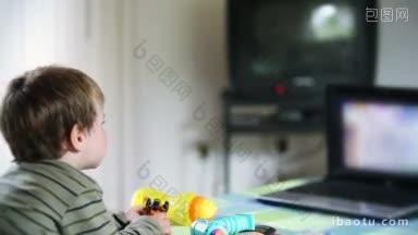 小男孩在电脑前看<strong>动画片</strong>，吃苹果