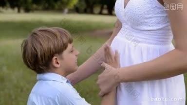 幸福的家庭和怀孕，孕妇和孩子把头靠在肚子上听婴儿的心跳