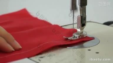 一名妇女正在一台工业缝纫机上缝纫