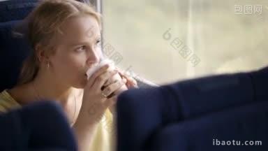 坐火车旅行时，沉思的金发年轻已婚女子一边喝着咖啡，一边望着窗外