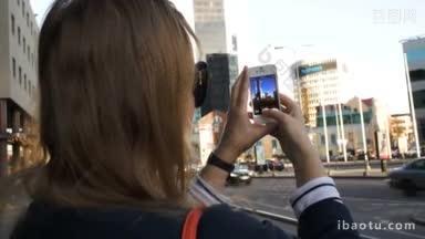 一个女人用智能手机<strong>拍摄</strong>现代<strong>城市</strong>建筑的特写镜头