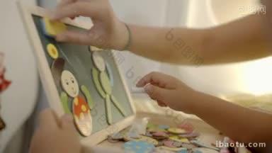 一个小孩用粉笔在黑板上画画的特写<strong>镜头</strong>，人物的母亲正在擦拭他的笔画