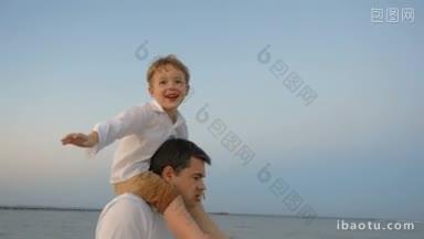 慢镜头里，快乐的小男孩坐在父亲的肩膀上模仿飞机，他们在海边散步