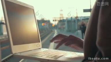 日落时分，一个女人在火车站用笔记本电脑打字，她<strong>结束</strong>了工作离开了