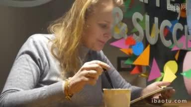 斯坦尼康<strong>拍摄</strong>的一个年轻女子花<strong>时间</strong>在咖啡馆她吃冰淇淋和享受聊天的平板电脑