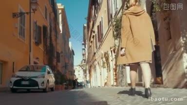 斯坦尼康和低角度拍摄的一个女人在外套走在古老的狭窄的街道在<strong>欧洲</strong>她