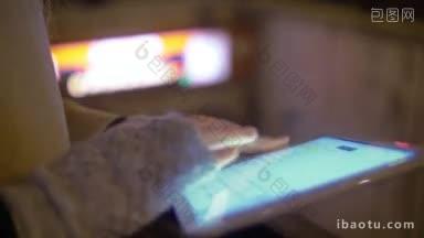 近距离拍摄的妇女使用平板电脑在地下入口的街道在夜晚led显示屏与