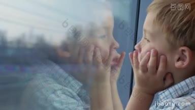一个小男孩在火车上旅行的特写镜头他看着<strong>窗外</strong>他的手放在脸上