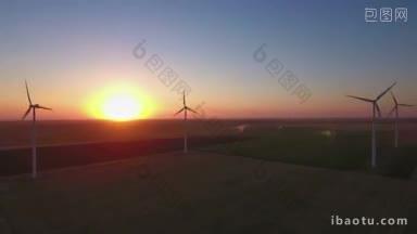 日落时风力发电场的大型风力涡轮机的鸟瞰图，可生产可持续和可再生能源