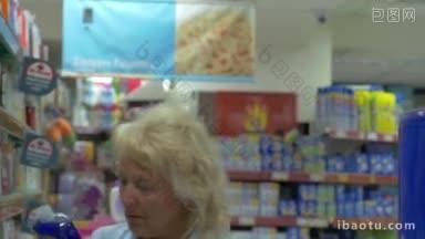 <strong>希腊</strong>佩雷亚市商店里的成年妇女从货架上挑选商品，把它放在