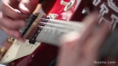 特写吉他手玩红色电吉他使用颤音技术在录音室干扰