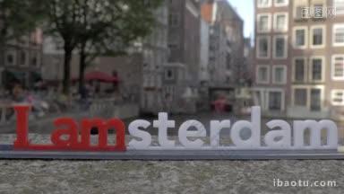 阿姆斯特丹字母<strong>雕塑</strong>在桥上的小塑料形象与堤上建筑模糊的城市<strong>景观</strong>的观点