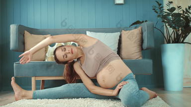 特写镜头微笑怀孕了女人瑜伽练习地板上
