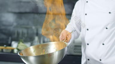 老板烹饪食物火火焰锅厨房老板手准备食物