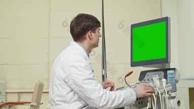 年轻的男性医生超声波扫描仪绿色屏幕