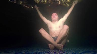 冥想概念男人。瑜伽手宽开放黑暗水下池基斯反射器呃股票镜头