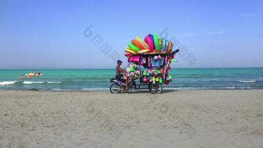 里约1月巴西约8月男人。骑移动商店销售玩具孩子海滩