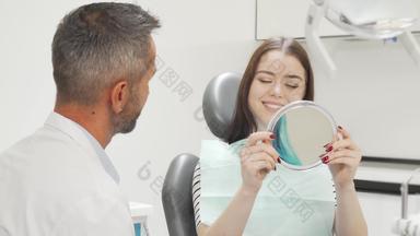 美丽的快乐女人会说话的牙医医疗检查