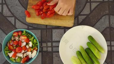 前视图人削减新鲜的蔬菜沙拉厨房表格切片西红柿准备维生素沙拉新鲜的蔬菜