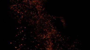 微粒子形式灰尘橙色散射黑色的背景