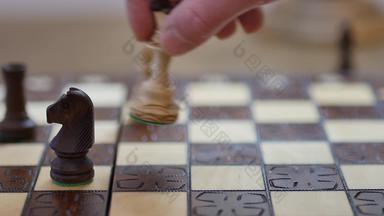 慢运动白色女王采取黑色的骑士男人。玩国际象棋游戏国际象棋董事会概念图像业务男人。持有国际象棋一块手国际象棋董事会游戏竞争概念