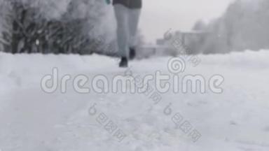 冬天在公园里沿着雪道奔跑的人的剪影