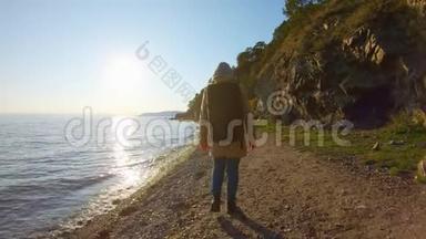 日落时分，背着背包的女孩在海边散步