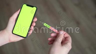 那个人拿着一个<strong>医用体温计</strong>和一个电话，在一个色度屏幕上。 冠状病毒的概念