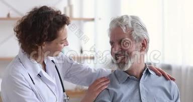 关爱善良的女医生拥抱令人放心的快乐老年病人