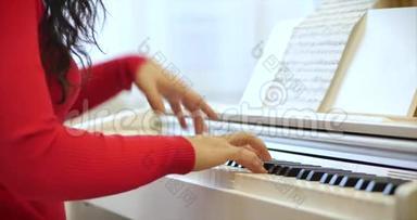 一名学生或专业<strong>钢琴</strong>家在一架漂亮的白色<strong>钢琴</strong>上演奏古典音乐，<strong>钢琴</strong>家的手