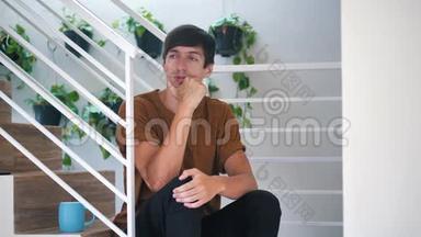 痛苦悲伤和沮丧的年轻人独自坐在家里的楼梯上：痛苦悲伤的人。