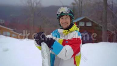 一个年轻人戴着头盔和滑雪板在一个山地度假活动公园的特写镜头。 寒假