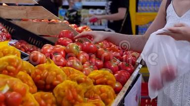 女人在超市里买东西，在超市里挑选烹饪、健康食品、西红柿等产品