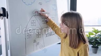 小女孩在家里用马克笔在白板上画画。