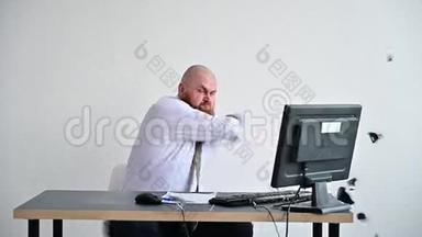 穿着衣服的疯狂商人在办公室的电脑上<strong>打碎</strong>了一个杯子。 这个人在工作上有问题和挫折。