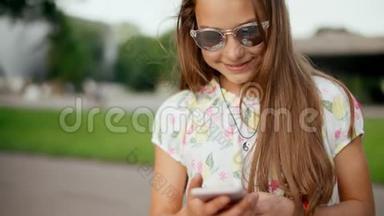在夏<strong>季</strong>公园，微笑的少女在<strong>手机</strong>上上网。