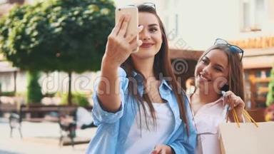 微笑的十几岁女孩正在通过智能手机自拍，正在夏季城市公园的背景。 复制空间。 快关门。 4K.