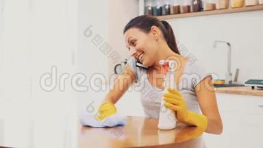 戴着黄色橡胶手套的女人正在<strong>厨房</strong>用除脂剂喷雾和布清洁烹饪<strong>面板</strong>。 作物。 复制空间