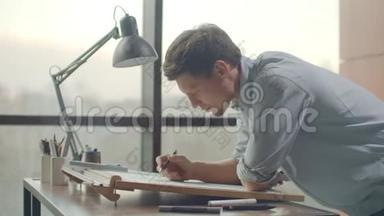 建筑师`办公桌：图纸，卷尺，直尺等绘图工具.. 工程师在明亮的办公室里画图纸
