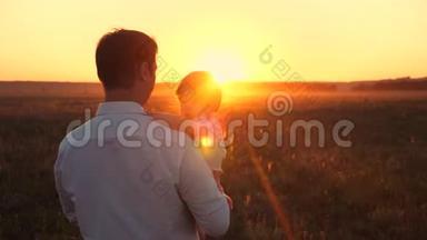 快乐的<strong>爸爸</strong>和他的小女儿在乡下散步。 一家人在日落时在公园休息。 <strong>爸爸</strong>手里拿着