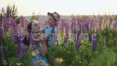 一家人幸福的母亲和孩子抱着野花在草地上