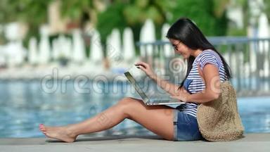 忙碌的自由职业者妇女微笑着在豪华度假酒店附近的笔记本电脑上工作