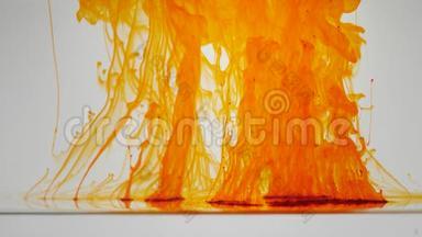 橙色粒子在白色背景上上升。 墨水颜料混合在水中，缓慢地向上移动。 抽象油墨背景