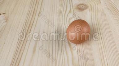 棕色的<strong>鸡蛋</strong>在木桌上旋转。 检查煮熟的<strong>鸡蛋</strong>的准备情况。 <strong>特写</strong>