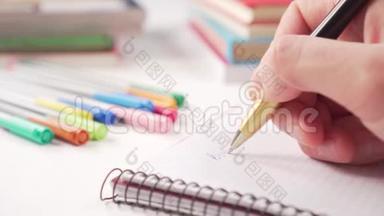 用黑色金色钢笔在白色桌子上的笔记本上手工书写，里面有多种颜色的创意和书籍的学习用品